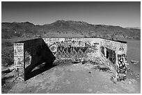 Aerial view of abandonned structure with graffiti and route 66 marker. Mojave Trails National Monument, California, USA ( black and white)