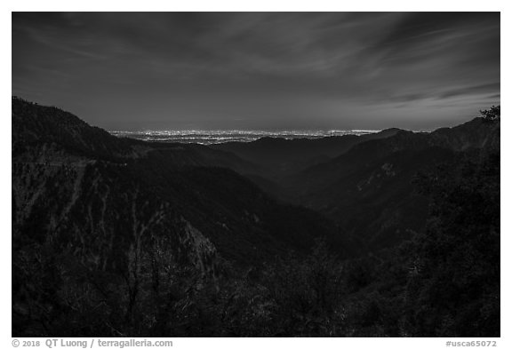 Mountains and distant Los Angeles Basin at night. San Gabriel Mountains National Monument, California, USA (black and white)