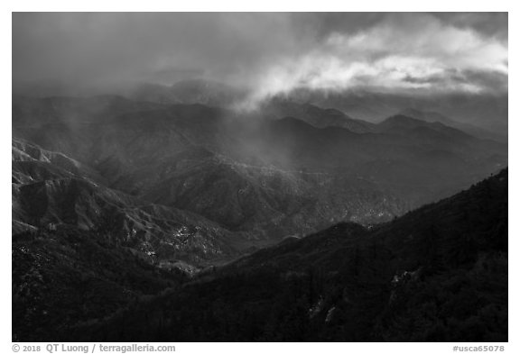 Rolling peaks under storm sky with shaft of light. San Gabriel Mountains National Monument, California, USA (black and white)