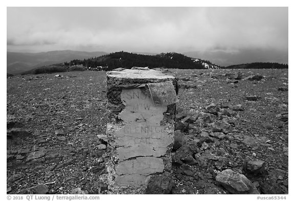 Snow Mountain West Summit marker with Tibetan prayer flags. Berryessa Snow Mountain National Monument, California, USA (black and white)