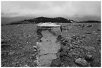 Snow Mountain West Summit marker with Tibetan prayer flags. Berryessa Snow Mountain National Monument, California, USA ( black and white)