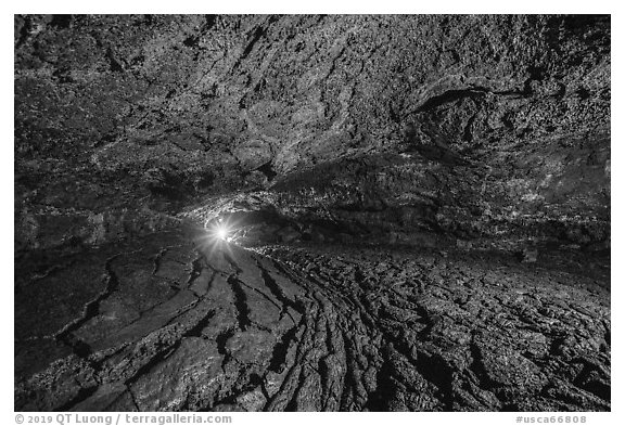 Golden Dome Cave with caver's light. Lava Beds National Monument, California, USA (black and white)
