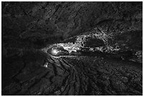 Caver in Golden Dome Cave. Lava Beds National Monument, California, USA ( black and white)