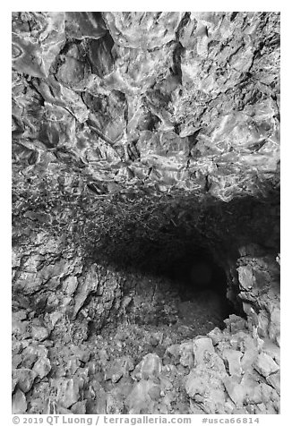 Hiker at entrance of Skull Cave. Lava Beds National Monument, California, USA (black and white)