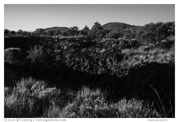 Lava depression and distant buttes. Lava Beds National Monument, California, USA (black and white)
