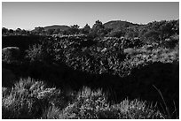 Lava depression and distant buttes. Lava Beds National Monument, California, USA ( black and white)