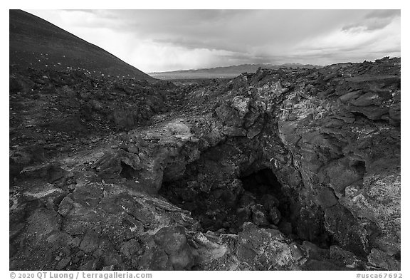 Pisgah Cinder cone and entrance to lava tube cave. Mojave Trails National Monument, California, USA