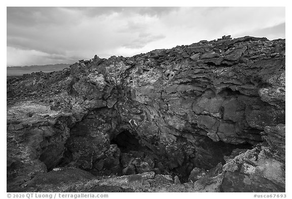 Depression and entrance to lava tube cave. Mojave Trails National Monument, California, USA
