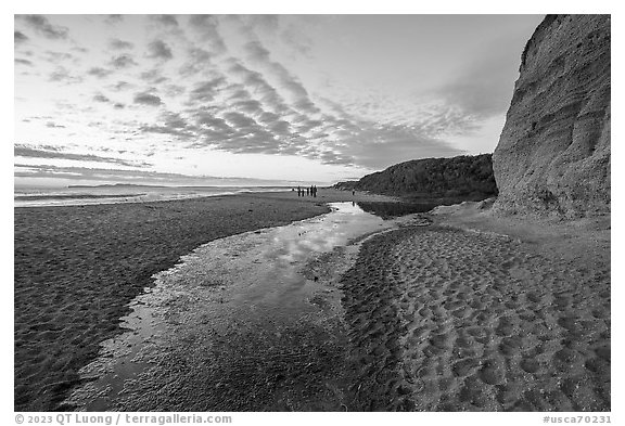 Tidal pond at sunset and visitors on beach, Santa Maria Beach. Point Reyes National Seashore, California, USA (black and white)