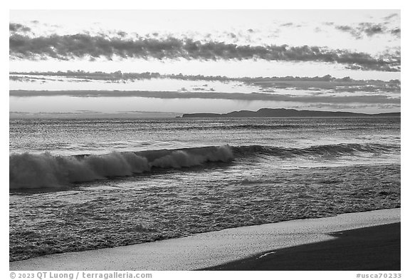 Surf and distant Point Reyes at sunset. Point Reyes National Seashore, California, USA