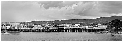 Fishermans Wharf colorful buildings at sunset. Monterey, California, USA (Panoramic black and white)