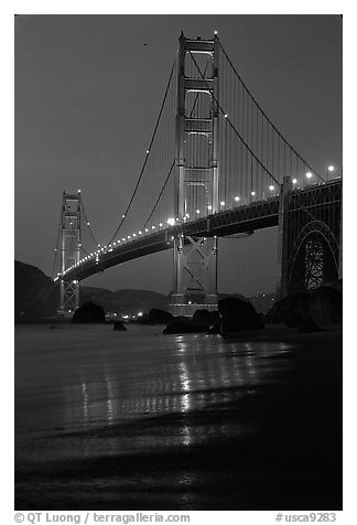 Golden Gate bridge and surf seen from E Baker Beach, dusk. San Francisco, California, USA (black and white)