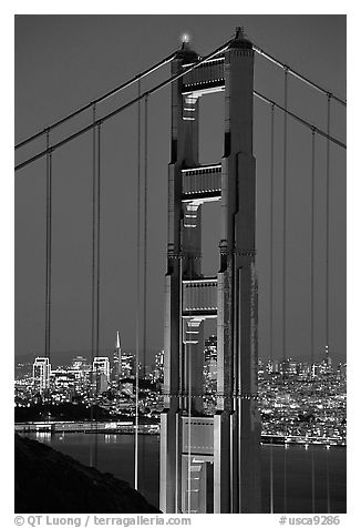 The city seen through the cables and pilars of the Golden Gate bridge, night. San Francisco, California, USA