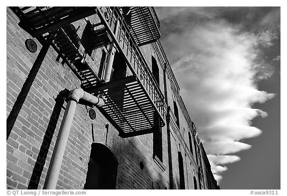 Old brick building and serrated cloud, sunset, Fisherman's Wharf. San Francisco, California, USA (black and white)
