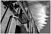 Old brick building and serrated cloud, sunset, Fisherman's Wharf. San Francisco, California, USA (black and white)