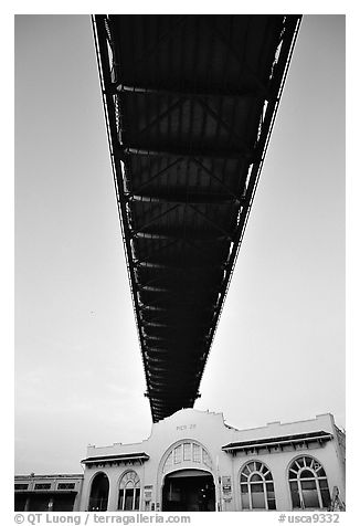 Bay Bridge dwarfs Pier 26 building. San Francisco, California, USA (black and white)