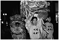 Lion dancers  during the Chinese New Year celebration. San Francisco, California, USA (black and white)