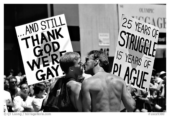 Gay couple with signs during the Gay Parade. San Francisco, California, USA