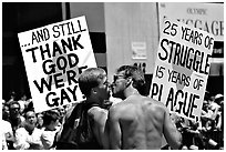 Gay couple with signs during the Gay Parade. San Francisco, California, USA (black and white)