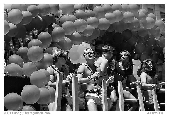 Men with rainbowed ballons on a float during the Gay Parade. San Francisco, California, USA