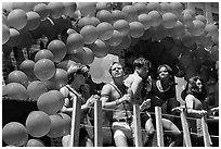 Men with rainbowed ballons on a float during the Gay Parade. San Francisco, California, USA (black and white)