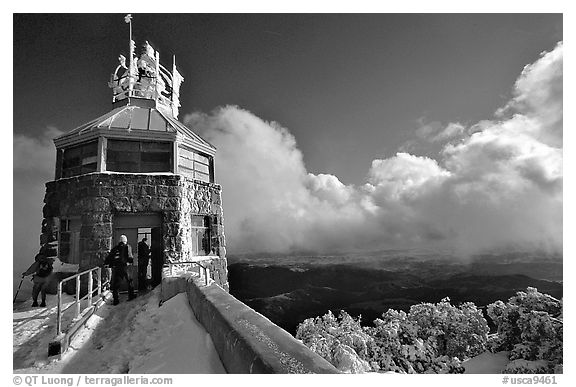 Hikers take refuge in the ice-clad summit tower during a cold winter day, Mt Diablo State Park. California, USA (black and white)