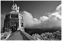 Hikers take refuge in the ice-clad summit tower during a cold winter day, Mt Diablo State Park. California, USA (black and white)