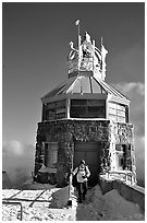 Hiker gets out of the ice-clad summit tower during a cold winter day, Mt Diablo State Park. California, USA (black and white)