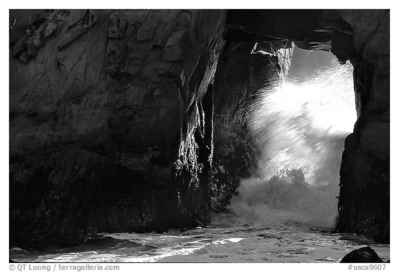 Light and wave through Arch Rock at Pfeiffer Beach. Big Sur, California, USA (black and white)