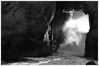 Light and wave through Arch Rock at Pfeiffer Beach. Big Sur, California, USA (black and white)