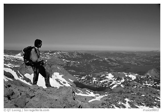 Hiker standing on top of Round Top Peak. Mokelumne Wilderness, Eldorado National Forest, California, USA