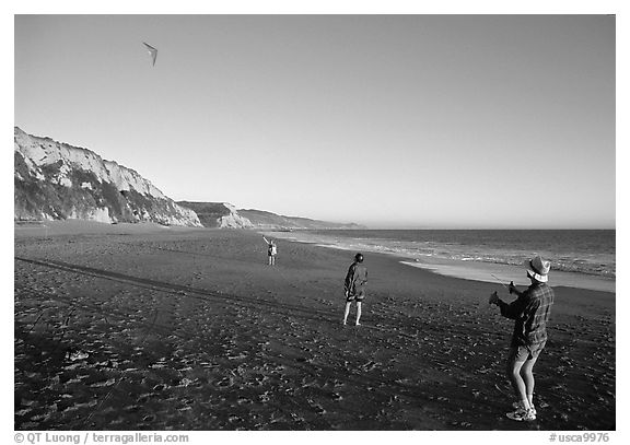 Flying a kite at Santa Maria Beach, late afternoon. Point Reyes National Seashore, California, USA (black and white)