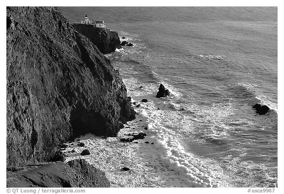 Cliffs, waves,  and Point Bonita Lighthouse, late afternoon. California, USA (black and white)