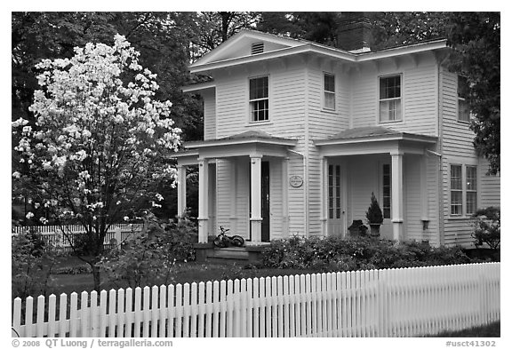White picket fence and house, Essex. Connecticut, USA (black and white)