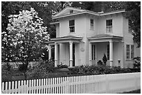 White picket fence and house, Essex. Connecticut, USA (black and white)