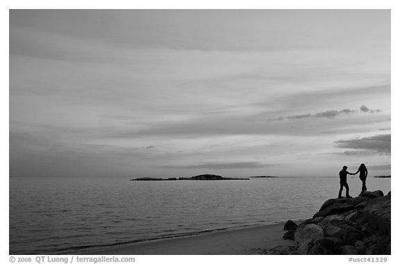 Beach with atlantic sunset and couple, Westbrook. Connecticut, USA (black and white)