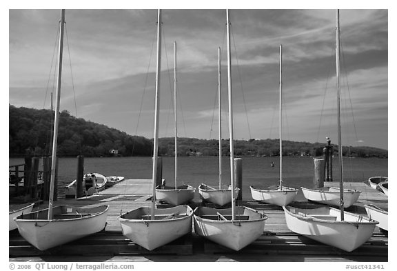 Small sailboasts parked on deck and Mystic River. Mystic, Connecticut, USA (black and white)