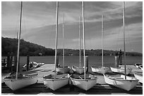 Small sailboasts parked on deck and Mystic River. Mystic, Connecticut, USA ( black and white)