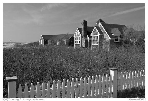 Fence and cottages in winter, Truro. Cape Cod, Massachussets, USA (black and white)