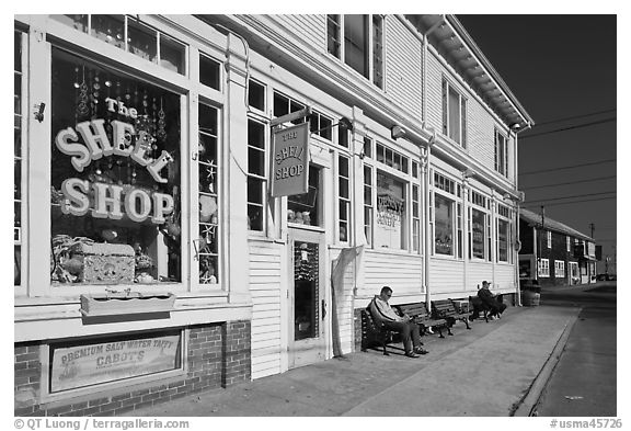 Men sitting on sidewalk benches, Provincetown. Cape Cod, Massachussets, USA (black and white)