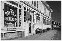 Men sitting on sidewalk benches, Provincetown. Cape Cod, Massachussets, USA (black and white)