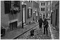 Women walking dog on rainy day, Beacon Hill. Boston, Massachussets, USA (black and white)