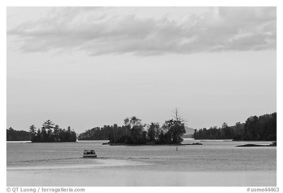Motorboat and islets at sunset,  Moosehead Lake, Greenville. Maine, USA (black and white)