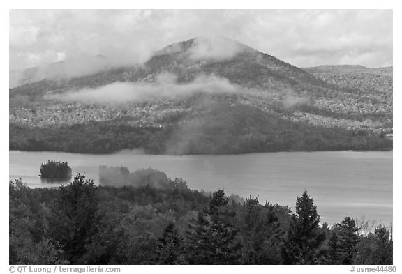 Autumn scenery with lake and clouds lifting up. Maine, USA