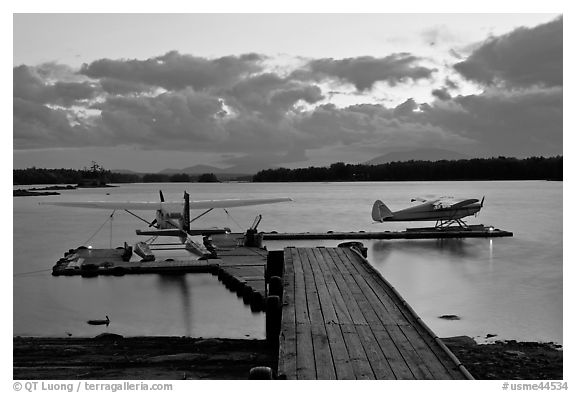 Seaplanes and dock at dusk, Ambajejus Lake. Maine, USA