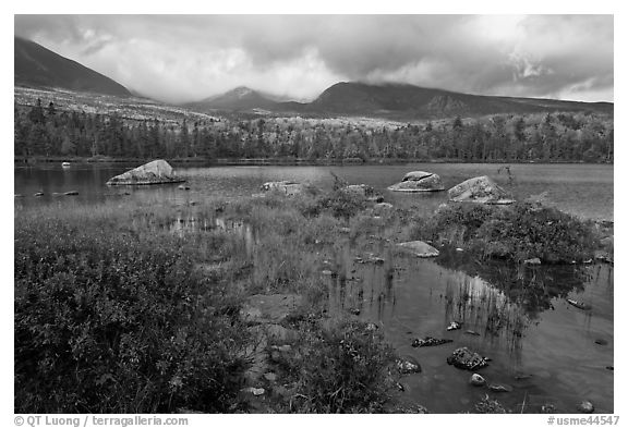 Mountains with fall colors rising above pond. Baxter State Park, Maine, USA