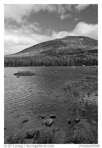 Forested mountain with fall foliage and pond. Baxter State Park, Maine, USA