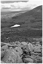 Hiker descends from summit amongst boulders above treeline. Baxter State Park, Maine, USA ( black and white)