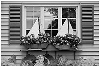 Window with flower pots shaped like sailboats. Bar Harbor, Maine, USA (black and white)