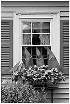 Window with decorative sailboat and flowers. Bar Harbor, Maine, USA (black and white)